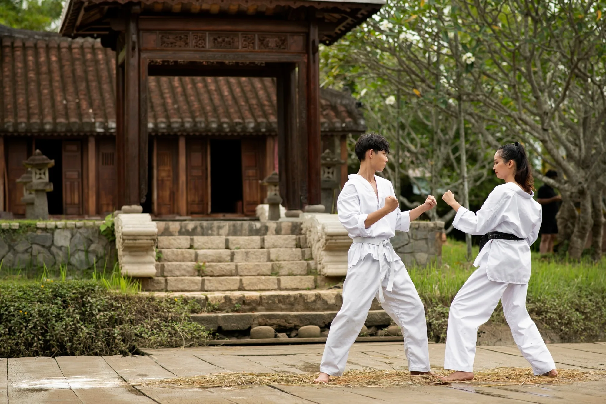 Two practitioners bowing on a traditional dōjō floor